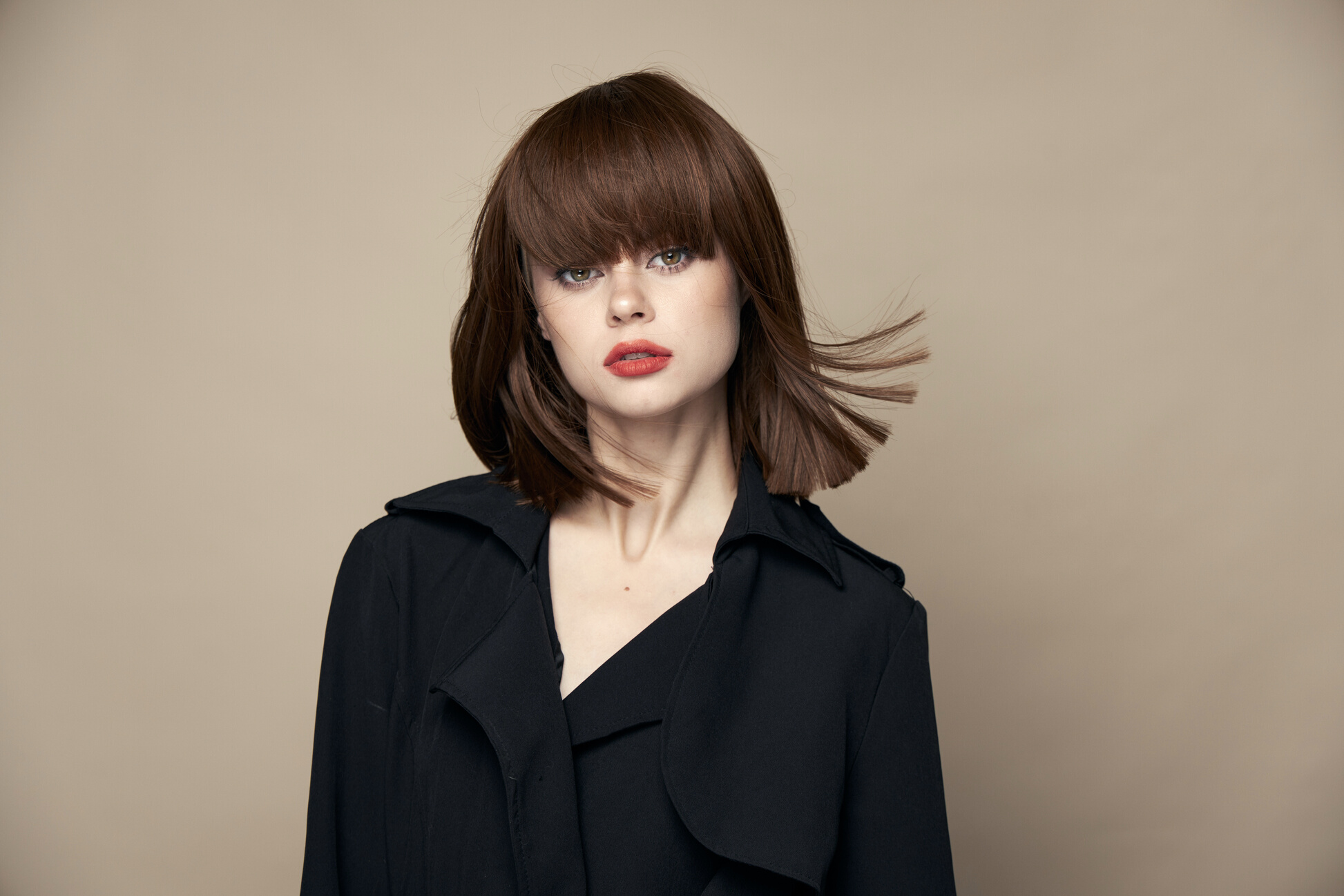 Attractive Brunette Stylish Clothes Bright Makeup Laughing on a Beige Background